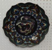 A Japanese Cloisonne plate decorated with a dragon, shaped edge, signed, 36cm diameter