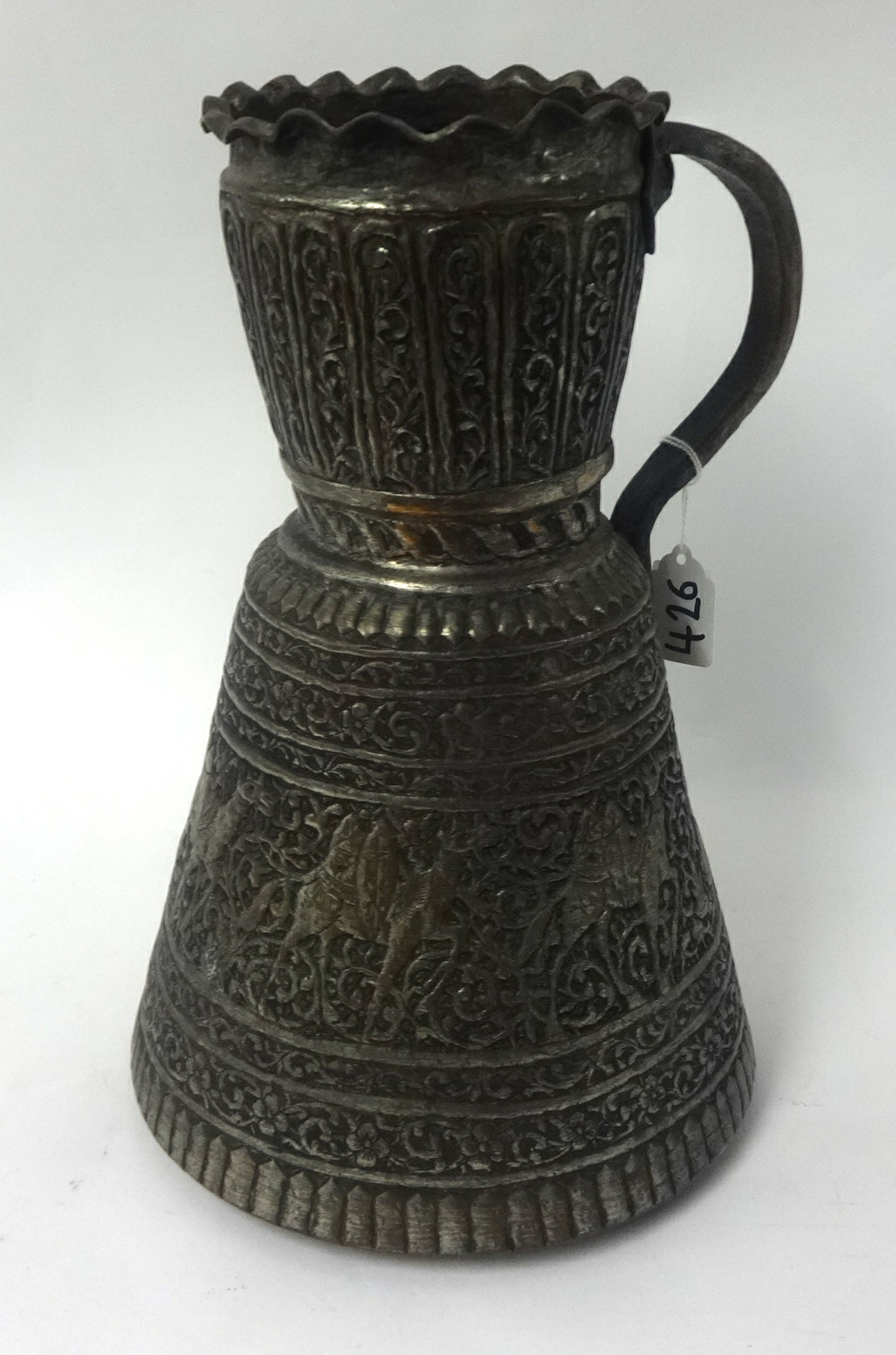 Middle Eastern flagon, copper with ornate decoration featuring camels, 30cm high