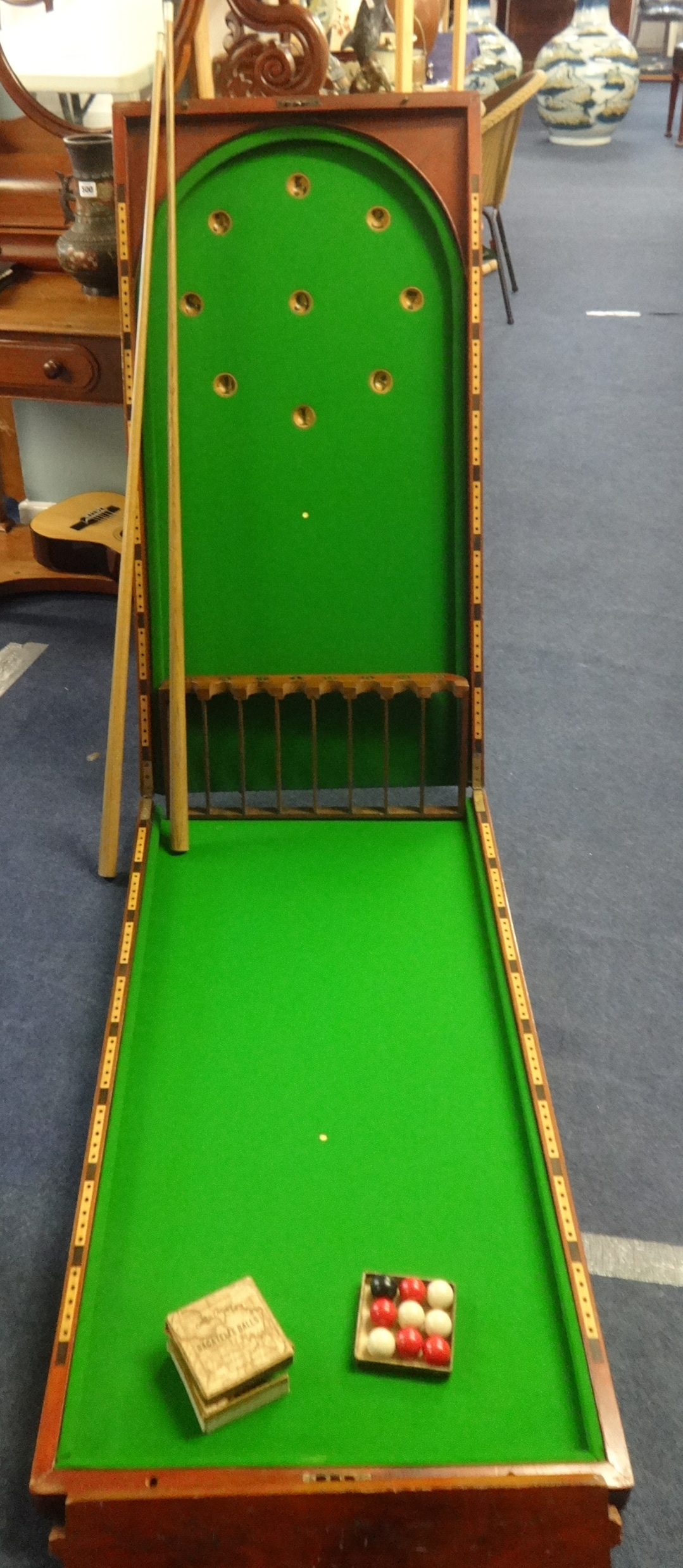 A Victorian mahogany folding table top Bar Billiard board opening to reveal a green baize, with