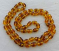 An amber style necklace, 62cm long