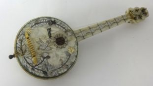 A miniature music box in the form of a banjo in mother of pearl