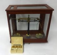 Set of scales in wood cabinet with weights, Baird and Tatlock, London