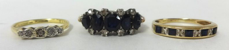 Five stone dark sapphire style ring and two others