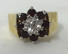 A 9ct gold garnet cluster ring set with round cut diamond, size N1/2