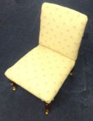 Upholstered nursing chair with brass castors