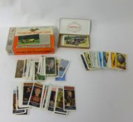 A collection of various cigarette cards including Black Cat