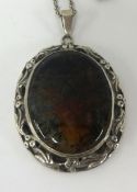 A silver and moss agate pendant on chain