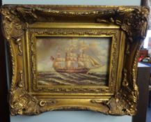 Pair of reproduction paintings of sailing ships in ornate gilt frames