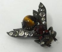 An insect brooch in the form of a fly set with various coloured stones