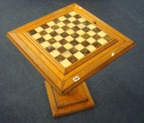A modern chess table with marble board and set of metal chess pieces