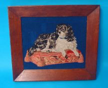 A tapestry picture of a spaniel on a cushion in oak frame, 24cm x 29cm