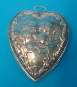 Large silver heart shaped paperclip decorated with cherubs