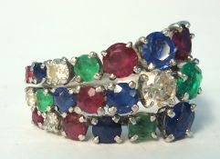 A white gold diamond, emerald, ruby and sapphire ring