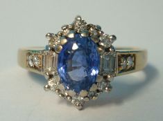 9ct gold diamond and Ceylon sapphire ring set with further diamonds to the shoulders, size P