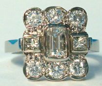 A diamond rectangular modern cluster ring set with an arrangement of princess, emerald and round