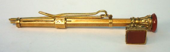 An Antique yellow metal ornate propelling  pencil with side seal, also a tie clip