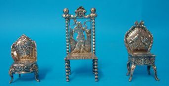 A silver miniature ornate chair 65mm high t/w two other similar ornate chairs (3)