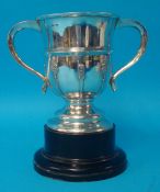 Silver twin handle cup, Goldsmiths and Silversmiths Ltd circa 1935, approx 18.80oz on wood socle,