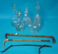 Four glass decanters, three scent bottles and riding crops