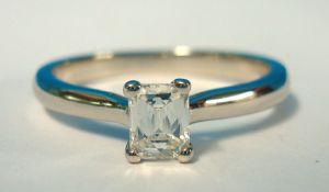 A nearly new Leo Diamond ring set in platinum, stamped 950, centre stone with single emerald cut