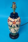 A modern Moorcroft `Band of Daisies` table lamp decorated with wild flowers, 33cm high