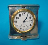 A silver cased folding travel clock