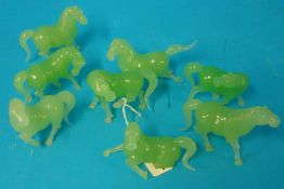 A group of modern green jade effect model horses on stands (8)