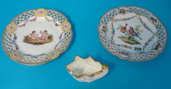 A pair of Dresden porcelain and pierced plates, one decorated with cherubs and the other with