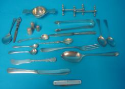 Various flat ware objects including silver tea strainer, sugar tongs etc