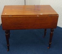 A Victorian mahogany drop flap Pembroke Table on turned legs and castors