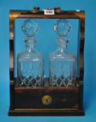 A two bottle Tantalus with key