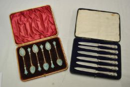 Six enamelled tea spoons, of Russian style, in fitted box, t/w six dessert knives with silver