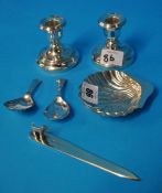 Silver letter knife with terrier dog mount, pair short silver candlesticks, silver scallop dish,
