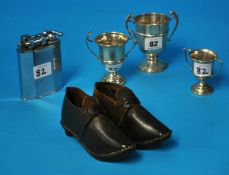 Three small silver cups, pair antique miniature clogs and large metal lighter
