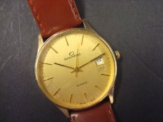 A gents Garrard gold wrist watch, with quartz movement and date