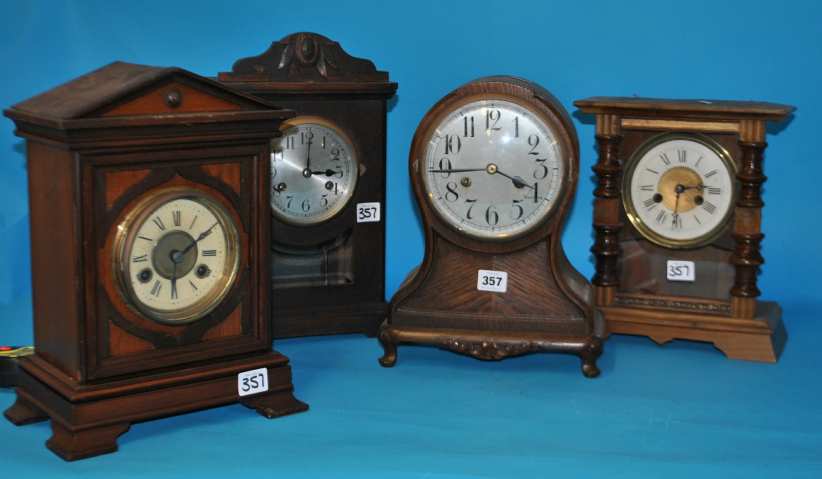 Four various Edwardian and later wood cased mantle clocks including eight day striking movement