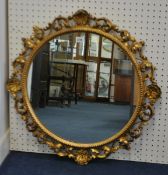 Circular carved and gilt framed mirror, 50cm diameter