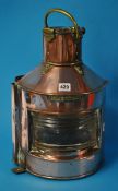 Copper bow port ship`s light and a copper bed warmer