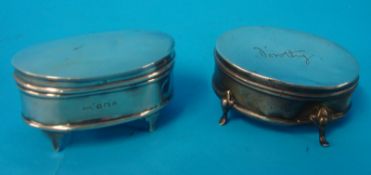 Two oval silver square boxes on feet