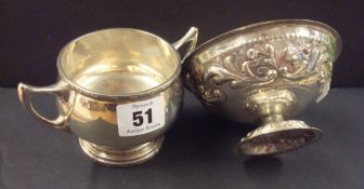 Silver sugar bowl with plain polished body, foliate decoration to border and two rising handles.