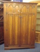 An oak two door wardrobe, 129cm wide, with key