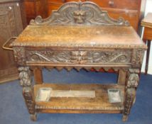 Victorian heavily carved oak hall table, fitted with drawer and drip trays