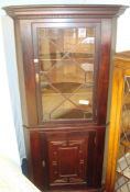 19th century mahogany corner cabinet, the upper section with astragal glazed single door and oak