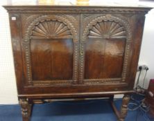 Antique carved oak cupboard on turned legs, 133cm wide