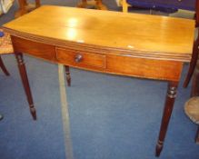 19th century mahogany fold over tea table on turned legs, fitted with a drawer (leg damaged)