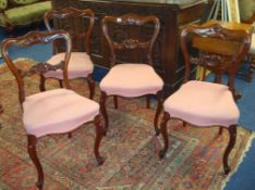 Set of four early Victorian carved rosewood dining chairs with cabriole legs and overstuffed seats