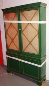 A modern green painted two part mirrored display cabinet of antique design