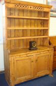 Old pine Welsh dresser with three open shelves over two panelled cupboard doors