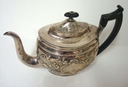 Georgian silver tea pot with embossed decoration