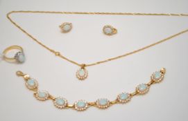 A suite opal and white sapphire set jewellery in 14ct yellow gold, stamped .585, comprising